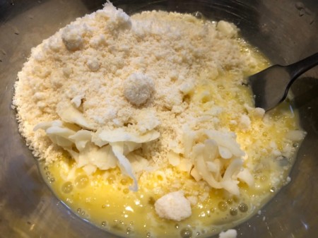 mixing eggs and cheese