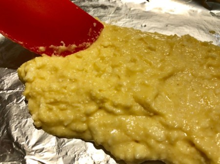 spreading dough on baking sheet