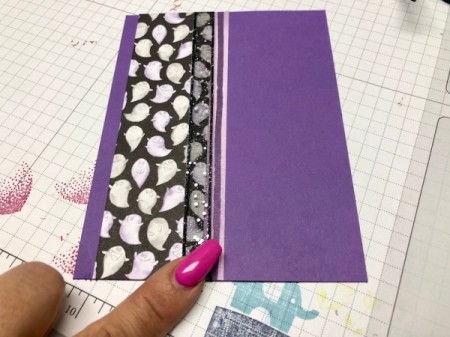 Two patterned papers placed side by side as a backdrop for the ghost decal.