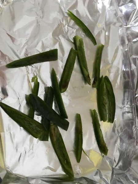 Fresh chile peppers on aluminum foil, ready for roasting