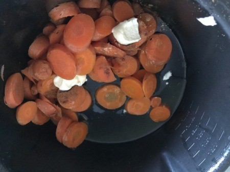 adding butter and spices to  Carrots