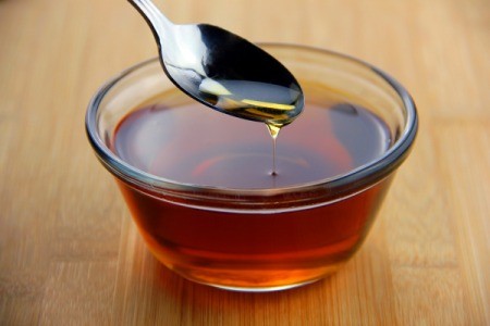 Bowl of syrup with a spoon.