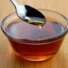 Bowl of syrup with a spoon.