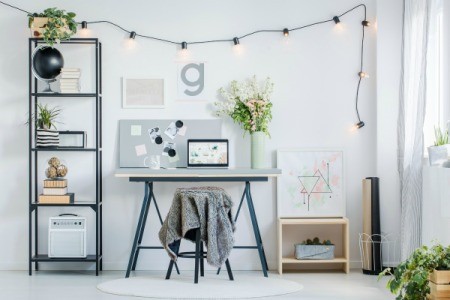 Apartment wall with shelf and desk.