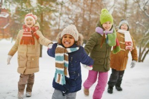 Kids happy playing in the snow.