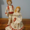 Identifying a Figurine - girl sitting with a boy standing behind her, both in period dress