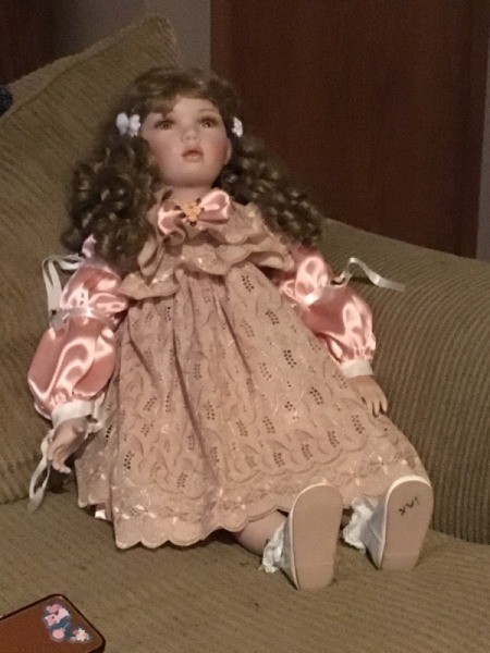 Value of a Porcelain Doll - doll wearing a pink lace and satin dress