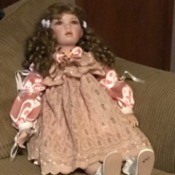 Value of a Porcelain Doll - doll wearing a pink lace and satin dress