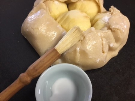 brushing Apple Galette with heavy cream