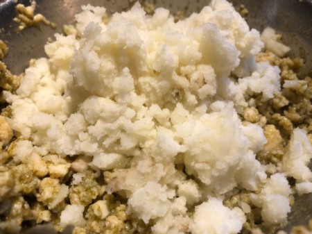 adding potato to pesto and chicken