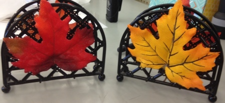 Artificial fall leaves placed on napkin dispensers.