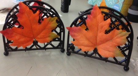 Artificial fall leaves placed on napkin dispensers.