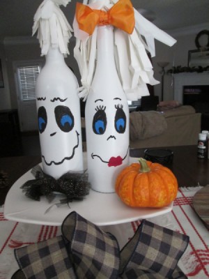 My Mr.& Mrs. Ghost Couple - bottles painted white and then decorated with faces and more to make ghosts