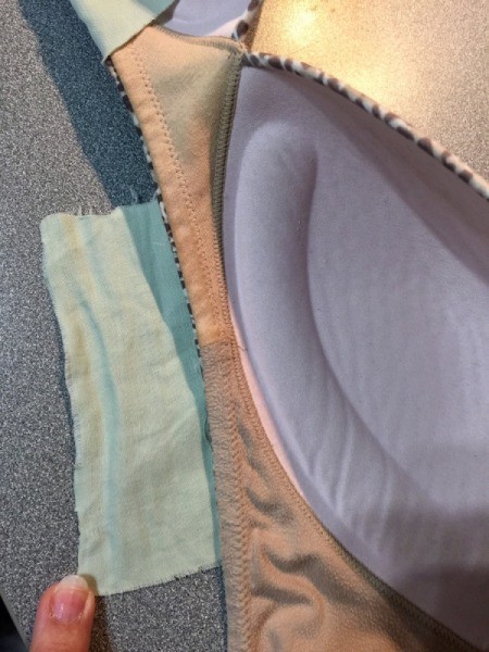 Bra with fabric patches attached to the underside of the bra cups.