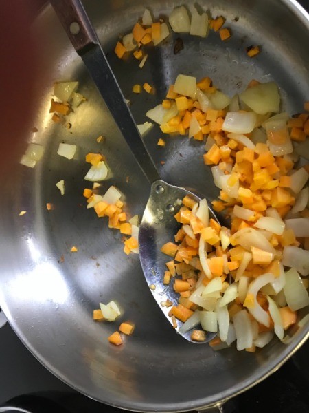 onions and carrots pieces in skillet