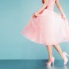 Woman in a pink prom dress with pink heels.