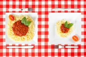 Big plate and small plate of spaghetti.