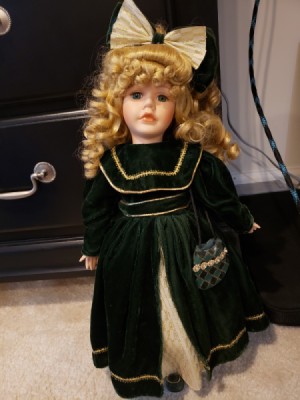 Value of a Collector's Choice Doll by Dandee - doll with gold ringlets, a large hair bow and a long dark coat
