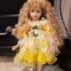Value of a Cathay Depot Collection Doll = doll with long blond ringlets, wearing a bright yellow dress