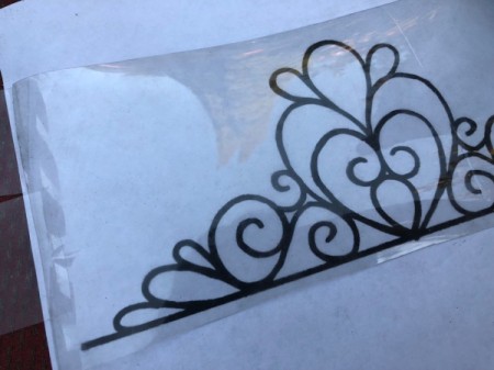 Plastic Bottle Tiara - place the tiara printout under the plastic, weigh it down