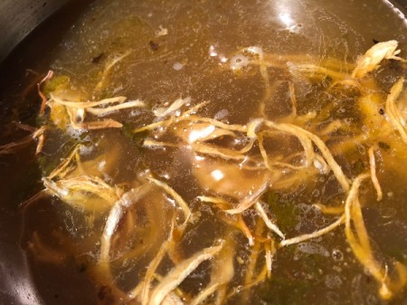 adding onions and carrots to Soup