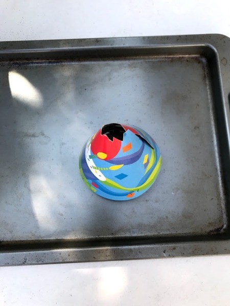 Party Hat Volcano Experiment for Kids - place the glass cup on a cookie sheet if desired cover with the hat and pour in the vinegar