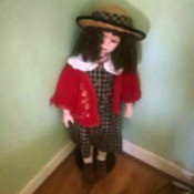 Value of a Limited Edition Knightsbridge Porcelain Doll - doll wearing a plaid dress and straw hat