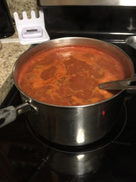 simmering sauce on stove
