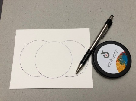 A step in making a Halloween card with a decorative pumpkin silhouette.