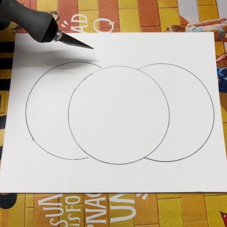 A step in making a Halloween card with a decorative pumpkin silhouette.