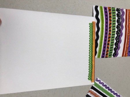 A step in making a Halloween card with a decorative pumpkin silhouette.