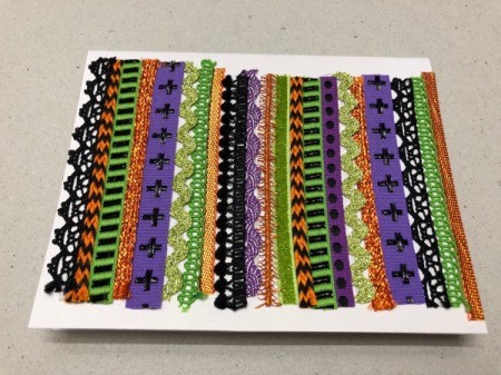 A step in making a Halloween card with a decorative pumpkin silhouette.