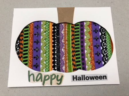 A finished Halloween card with a decorative pumpkin silhouette.