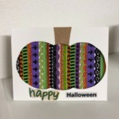 A finished Halloween card with a decorative pumpkin silhouette.
