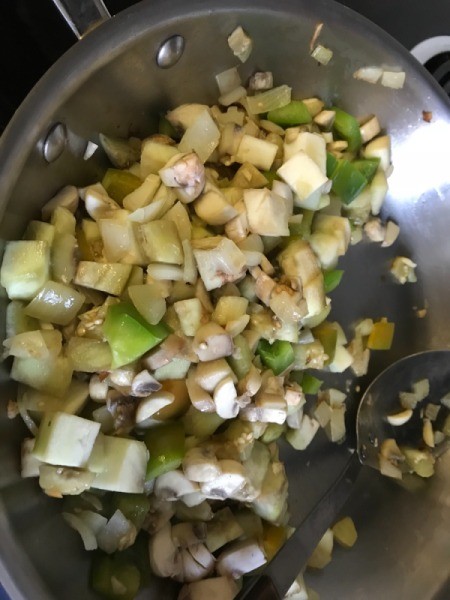onions, green peppers and mushrooms in pan
