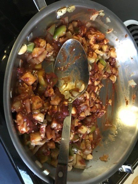 Eggplant and sauce added to pan