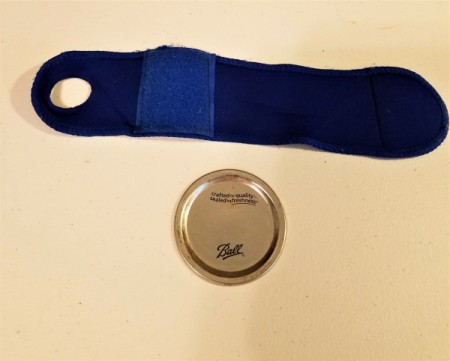 A wrist brace and a metal canning jar insert.