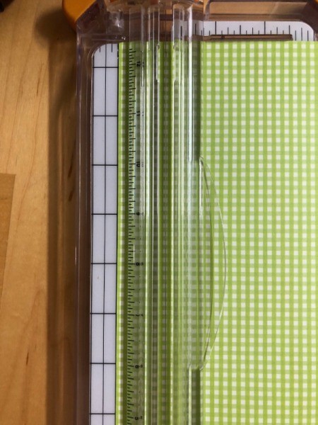 Pumpkin Garland - cutting a strip of green plaid paper