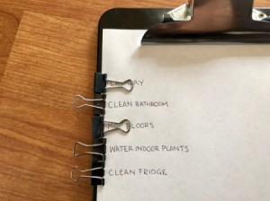 A clipboard with binder clips on the side to mark a to-do list.