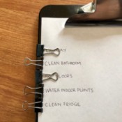 A clipboard with binder clips on the side to mark a to-do list.