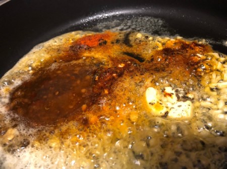 seasonings added to oil and butter in pan