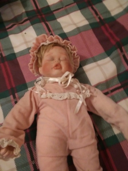 Value of Porcelain Dolls - sleeping baby doll in pink outfit