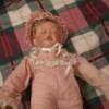Value of Porcelain Dolls - sleeping baby doll in pink outfit