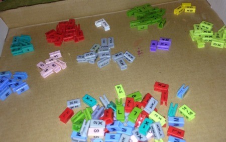 Colorful size markers from clothing hangers that can be used as a sorting activity for children.