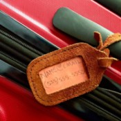 A luggage tag with just the person's email and telephone number listed.