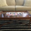 Value of a Glass Topped Vintage Coffee Table - table in front of a white couch