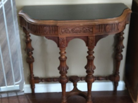 Value of a Mersman Half Circle Table - ornate wall table with 4 legs