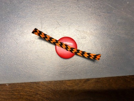 Spiderweb Display Sign - cut ribbon tape to glue to button to form legs