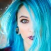 Woman with blue hair and blue eyes.