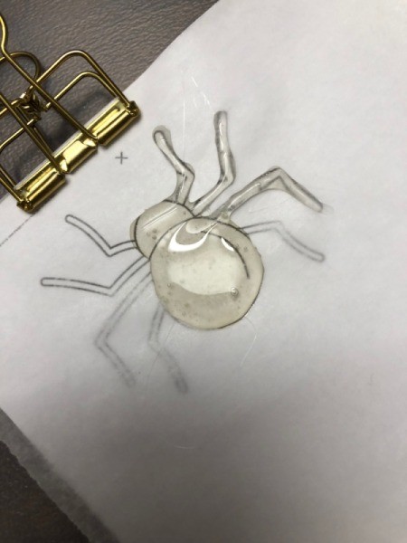 How to Make Hot Glue Spiders - place parchment paper over your spider image and begin covering with hot glue